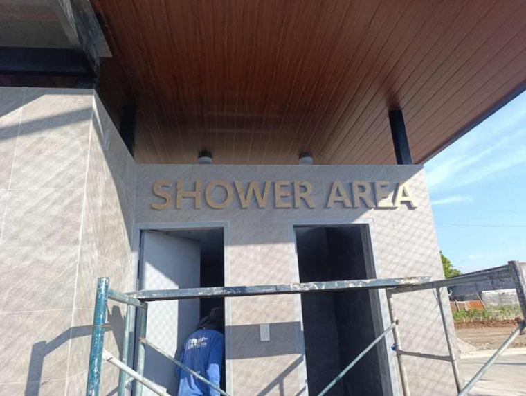 3D letter signage being installed on a wall