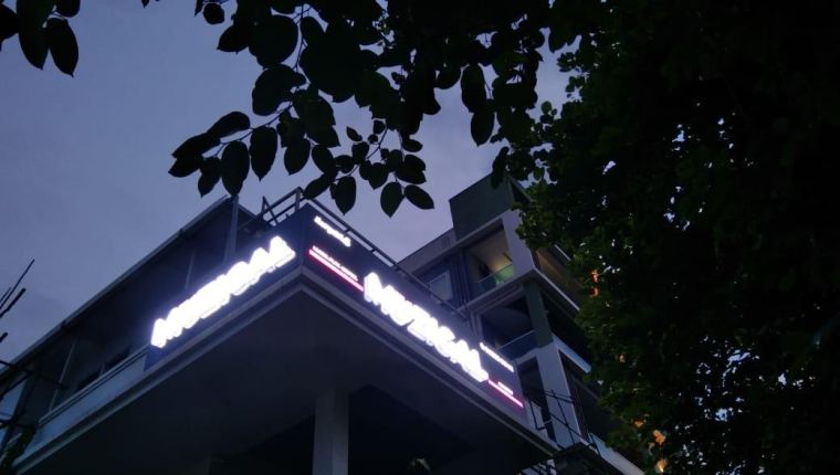 Building-top lit letters at night – CADMAP, Delhi