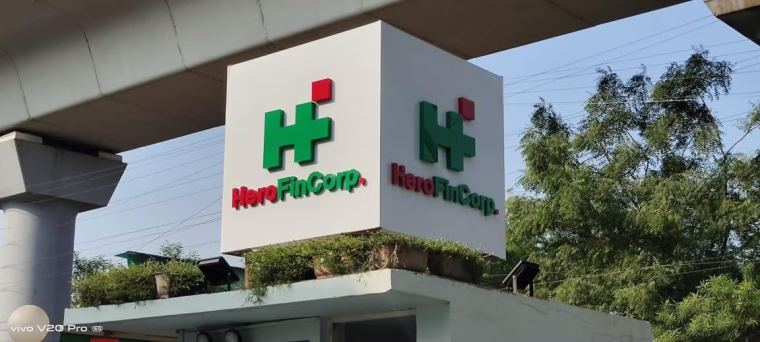 Double-sided acrylic flange signage mounted on a commercial building in Delhi