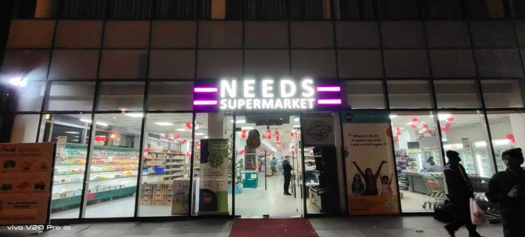 Illuminated supermarket storefront signage at night