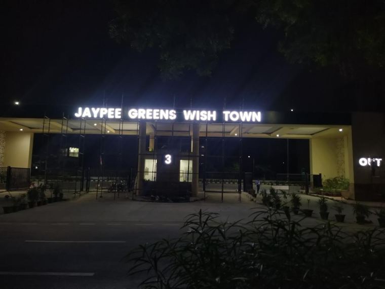 Illuminated LED letters on an entrance gate at night